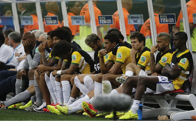 Photo of football team substitutes waiting on the bench
