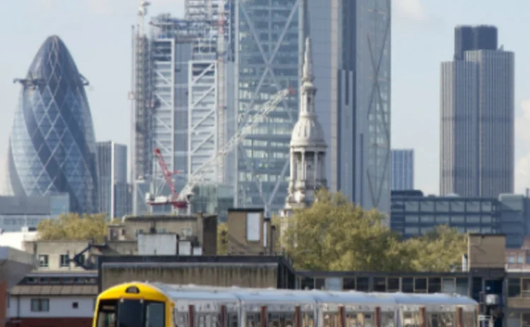 Train leaving London with City skyline behind image